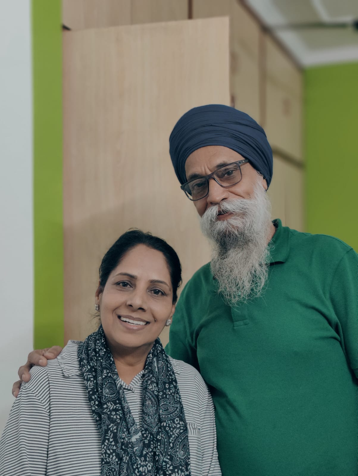 Rabinder Singh and wife smiling after full mouth implants